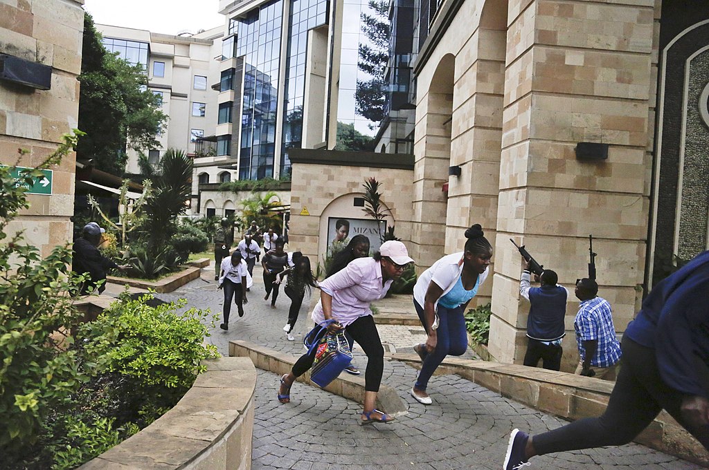 Civilians scamper to safety as plain clothe police provide cover at dusitd2 nairobi during the Suicide bombing and mass shooting attack on 15 January 2019 | commons.wikimedia.org | Shadychiri