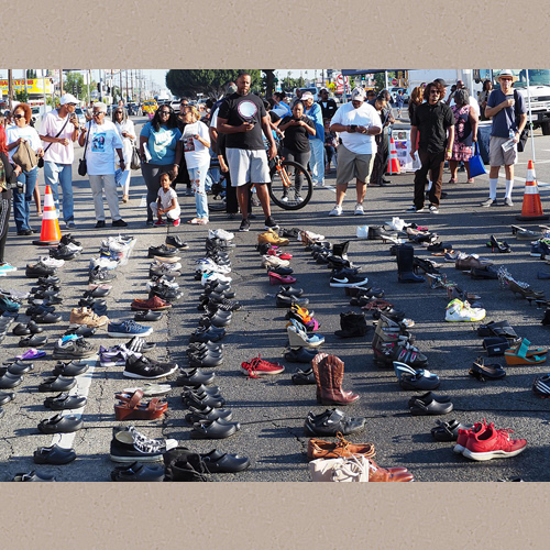 Local residents joined a lineup of leaders from throughout the county at the rally on July 13, 2018. People in attendance left pairs of shoes in the street at the corner of Manchester and Vermont to represent family and friends who were killed by guns. | wikimedia.org | Luke Harold | Date Created/Published: 13 July 2018